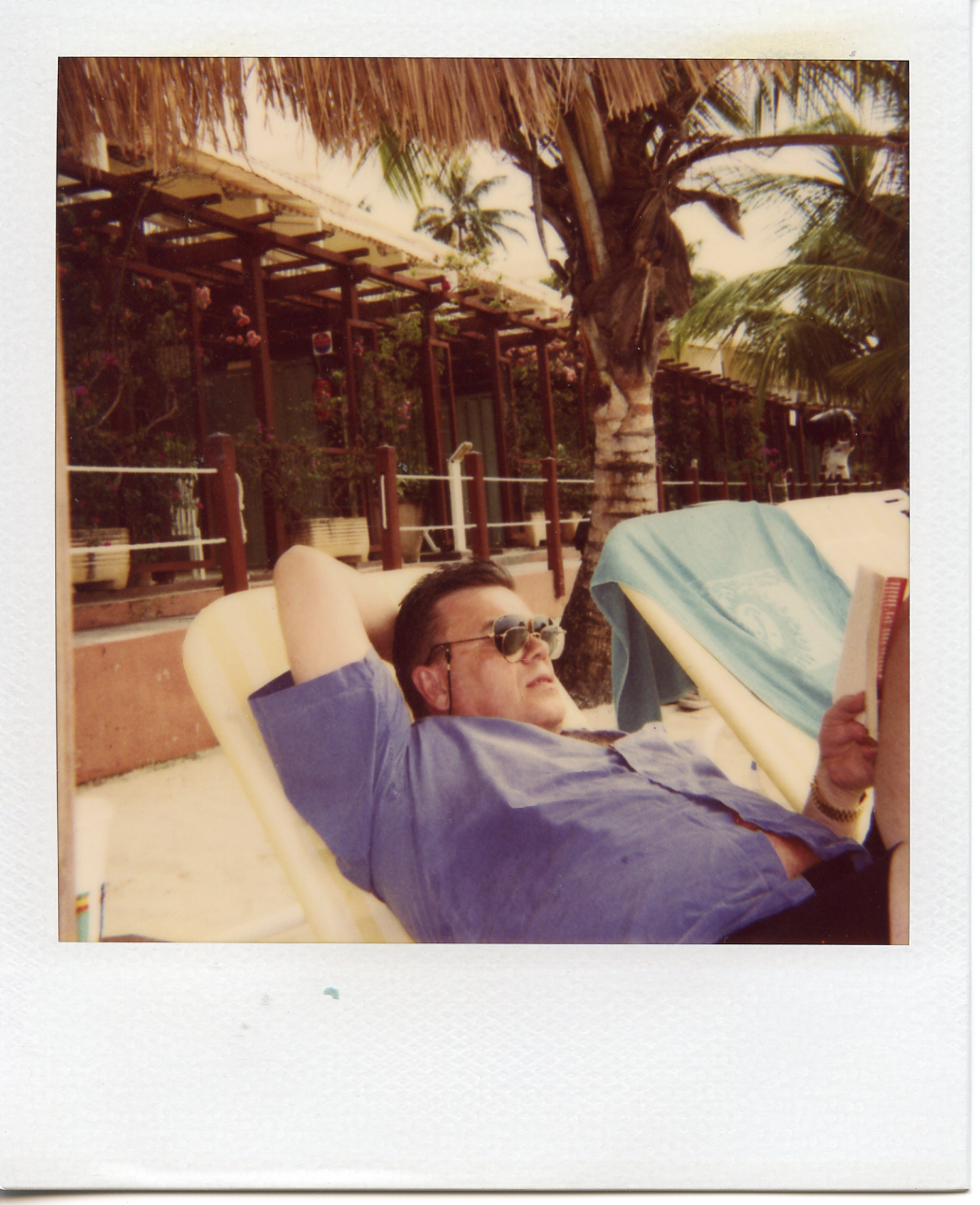 Dad on holiday, reading.